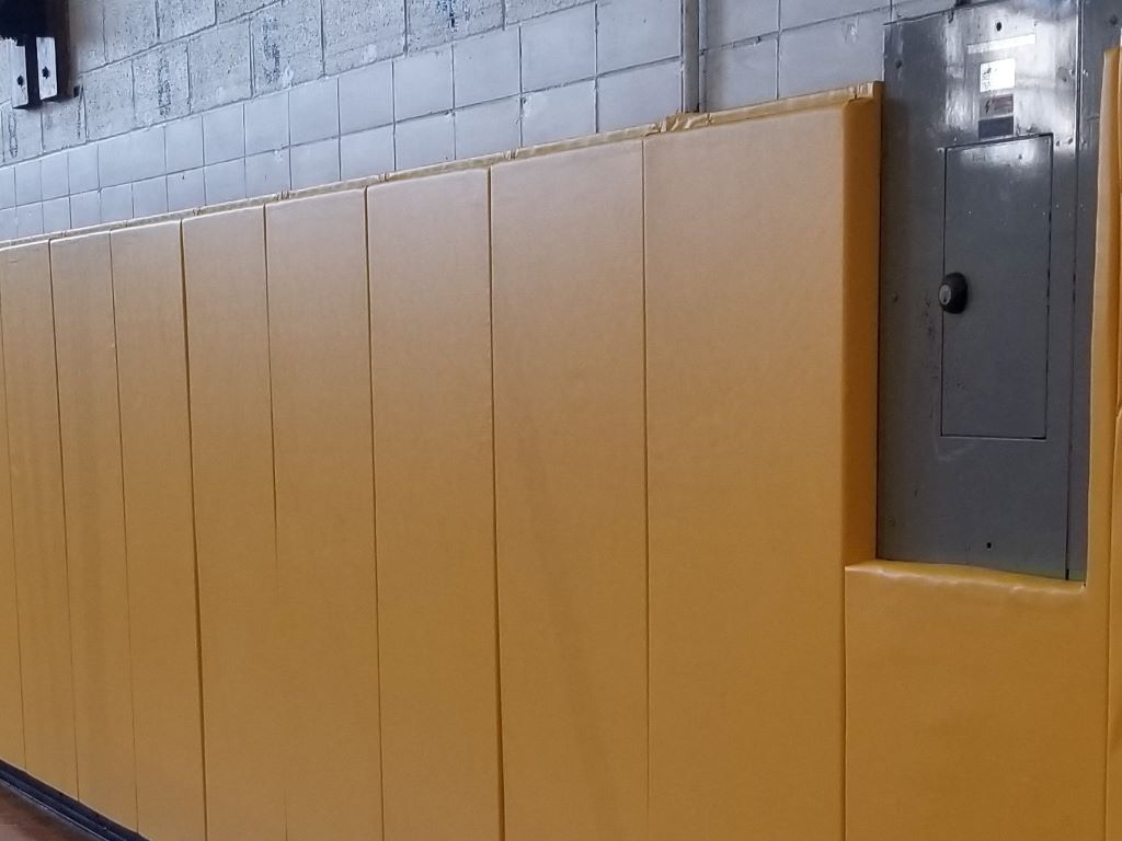 Yellow gymnasium wall safety pads 