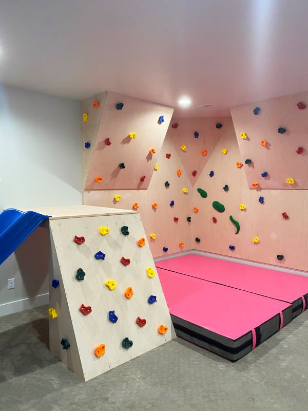 pink crash mat under climbing wall