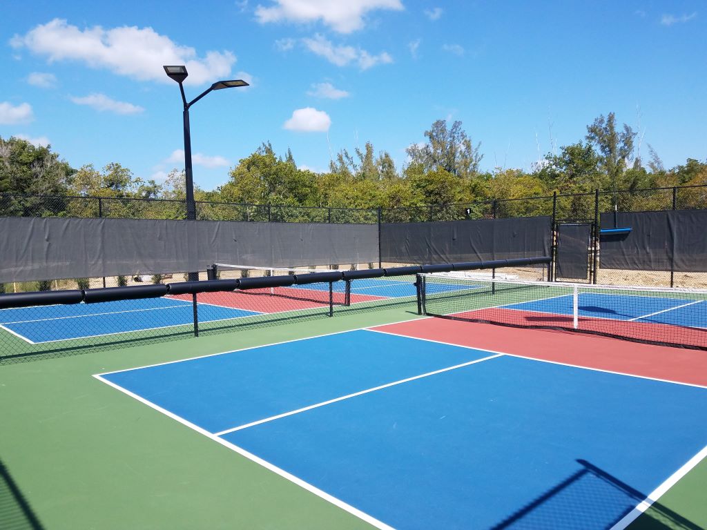 Fence pads on pickleball court 